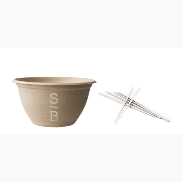 Sustainabowl branded compostable bowl and a pile of reusable metal chopsticks on a white background.