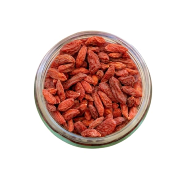 Overhead view of a glass jar filled with dried red goji berries, a healthy topping at Sustainabowl.